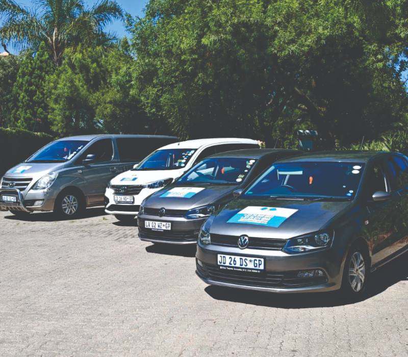 Fleet vehicles with boots open ready for airport luggage