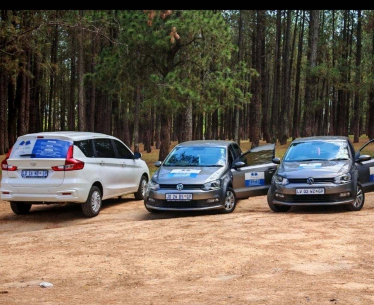 School transport vehicles with doors open ready for pick-up