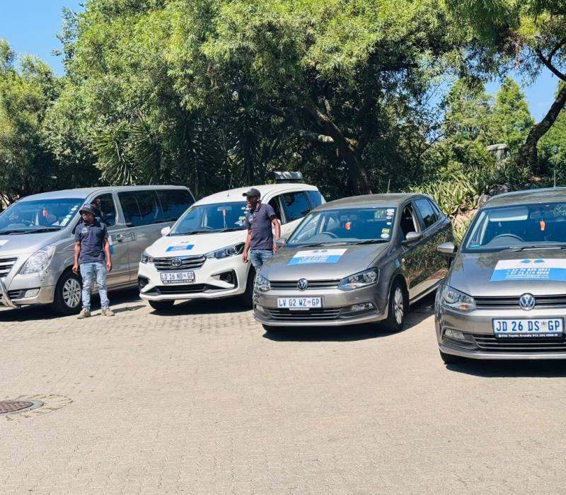Vehicles and drivers gathered for a Mini Me on Wheels team day